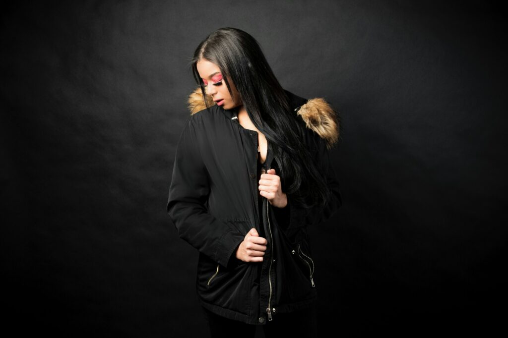 Shot of model wearing black jacket on black background